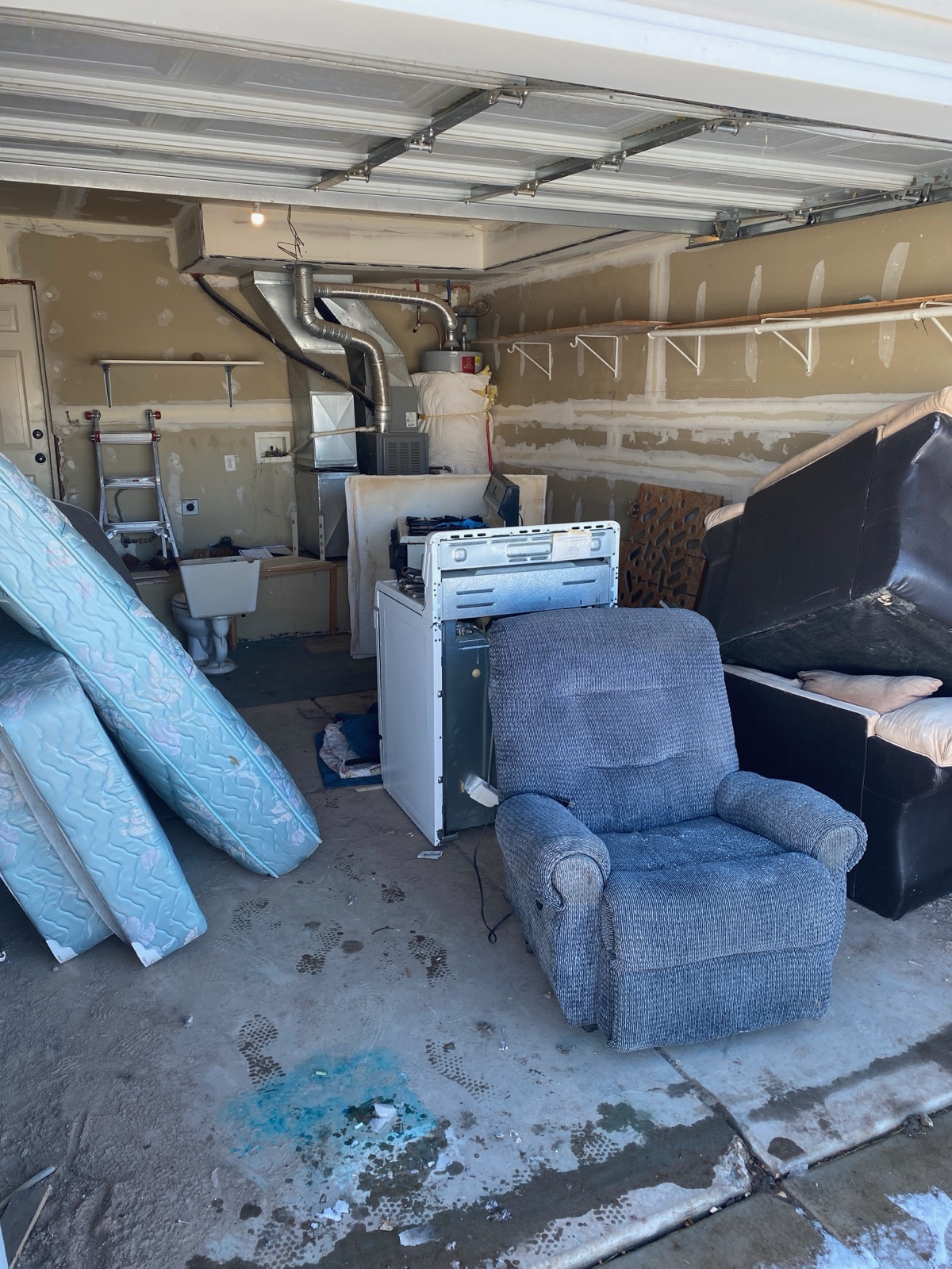 Garage full of furniture and appliances before cleanout