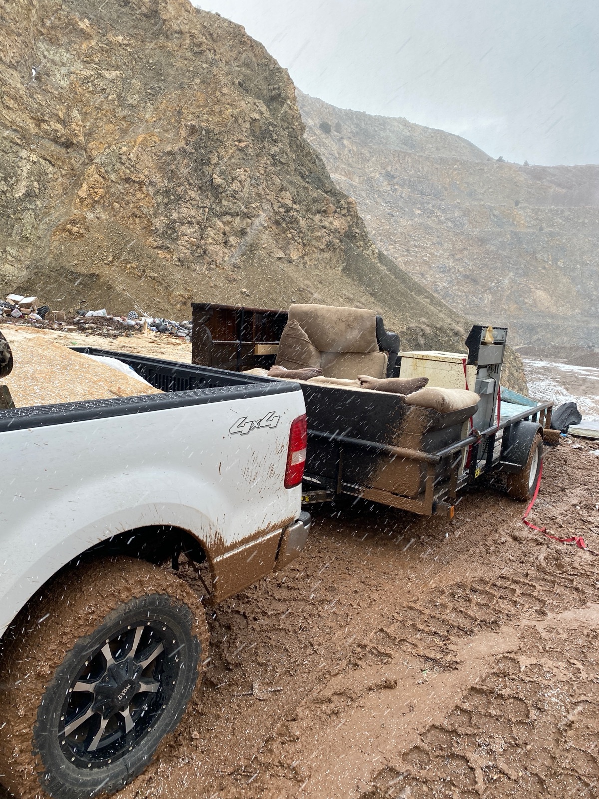 Hauling away furniture on a trailer in the snow